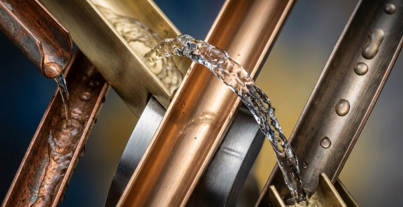 Close-up of water flowing through precision-engineered fountain system